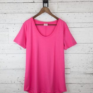 Pink t-shirt on wooden hanger, white background