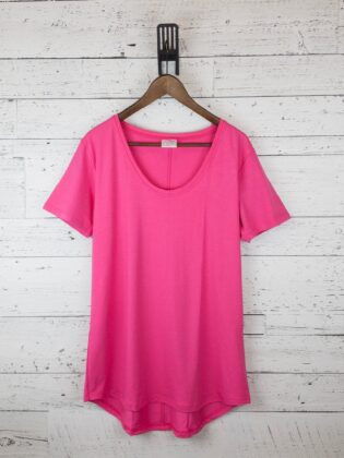 Pink t-shirt on wooden hanger, white background